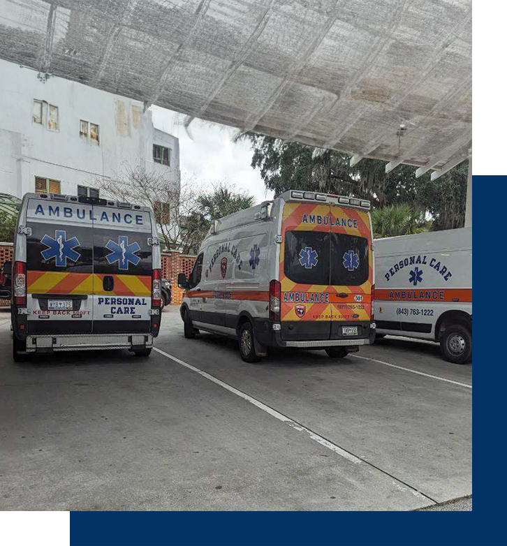 Three vans parked in a parking lot under a canopy.