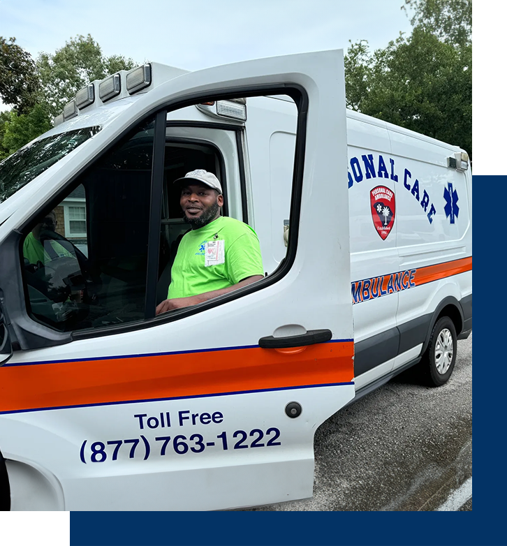 A man in the driver 's seat of an ambulance.