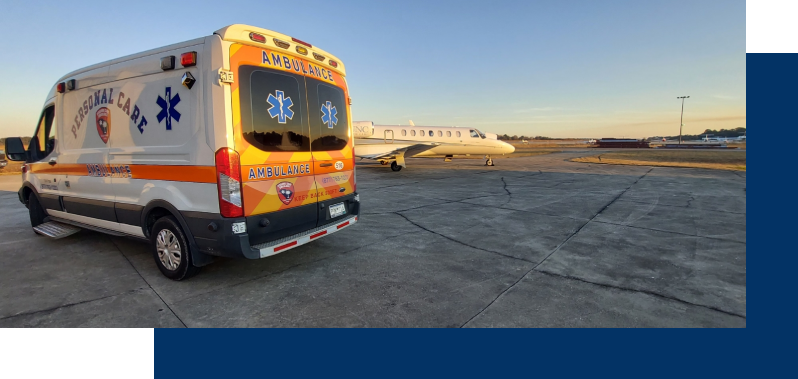 A yellow ambulance parked in front of an airplane.