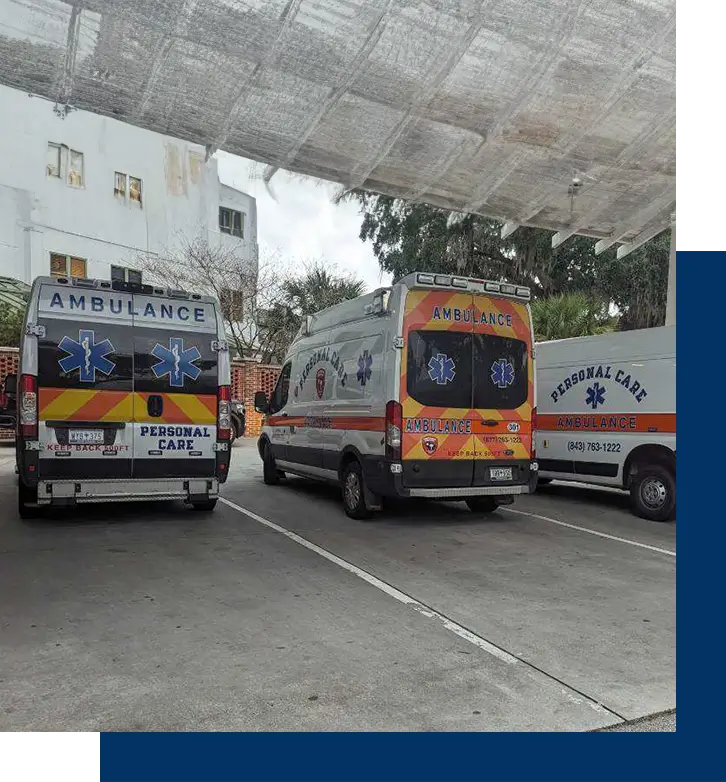 Three vans parked in a parking lot under a canopy.